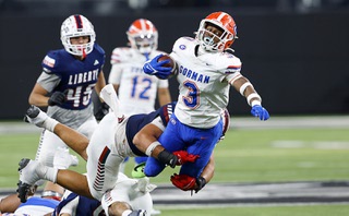 Bishop Gorman running back Devon Rice (3) is tackled by Liberty's Louden Williams (8) during the second half of the Class 5A Division I state championship football game at Allegiant Stadium Tuesday, Nov. 21, 2023.