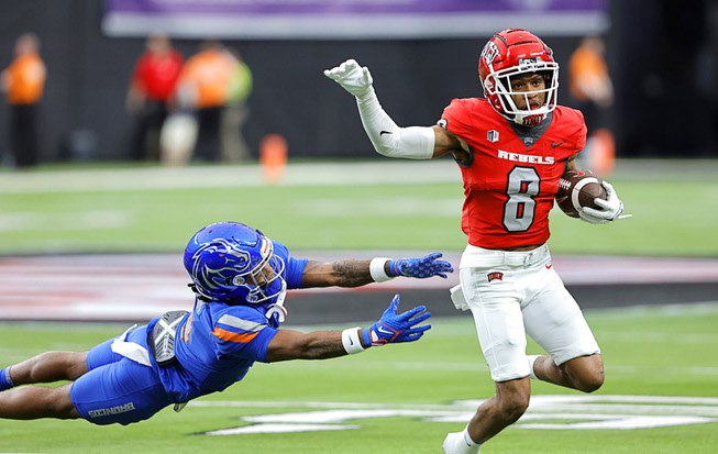 UNLV wide receiver Timothy Conerly (8) evades a tackle by Boise State safety Rodney Robinson (4) during the first half of the Mountain West championship game Saturday, Dec. 2, 2023.