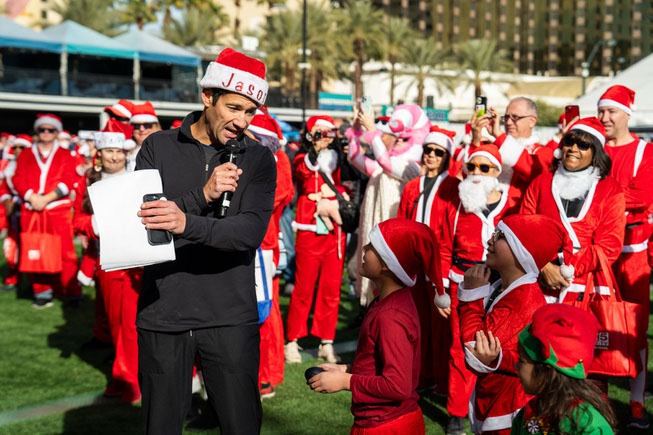 Host, Jason Feinberg from Fox 5 news, speaks to the kids in the crowd at the Las Vegas Great Santa Run on Saturday, December 2, 2023.