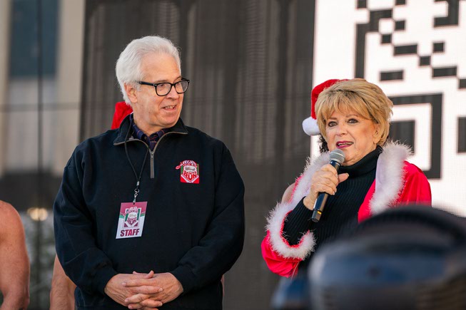Bob Brown, CEO of Opportunity Village and Mayor Carolyn Goodman present the proclamation for the Great Santa Run Day, downtown at the Las Vegas Events Center on Saturday, Dec. 2, 2023.
