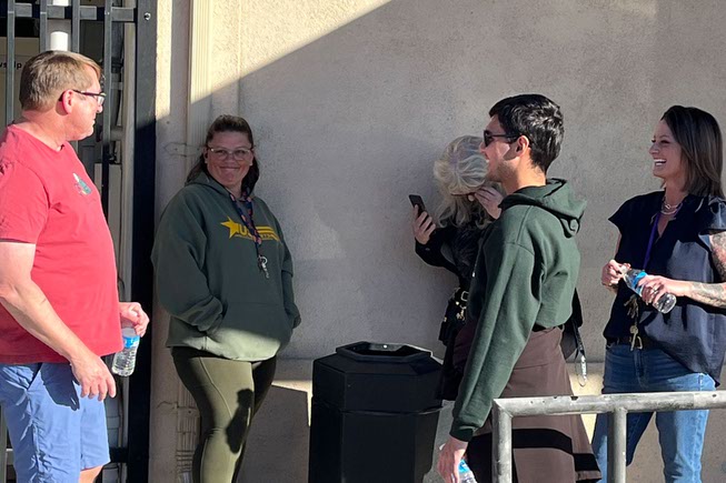 Pastor Stephen Govett, left, speaks with one of his staff members and near by preschool employees during the active shooting at UNLV.  University Church located across the street from the UNLV campus, offered help and water to students seeking shelter during the active shooter on Wednesday, December 6, 2023.