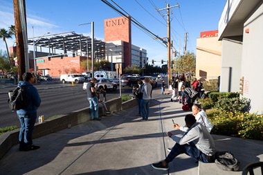 UNLV students wait along Maryland Parkway after being evacuated due to a fatal shooting after a fatal shooting on the UNLV campus Wednesday, Dec. 6, 2023.