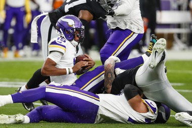 Minnesota Vikings quarterback Joshua Dobbs (15) gets sacked during the first half of an NFL football game against the Las Vegas Raiders at Allegiant Stadium Sunday, Dec. 10, 2023.