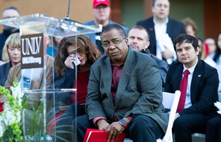Keith Whitfield, center, president of UNLV, listens to Rise Up sung by Christian Shelton during a memorial vigil at UNLV Wednesday, Dec. 13, 2023. Patricia Charlton, chancellor of the Nevada System of Higher Education, wipes her eyes at left. Three UNLV professors were killed and another critically wounded when a gunman opened fire in Beam Hall on UNLV campus Wednesday, Dec. 6.