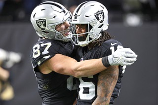 Las Vegas Raiders tight end Michael Mayer (87) embraces Las Vegas Raiders wide receiver Jakobi Meyers, right, after Meyers scored a touchdown against the Los Angeles Chargers during the first half of an NFL football game, Thursday, Dec. 14, 2023, in Las Vegas. (AP Photo/Steve Marcus)