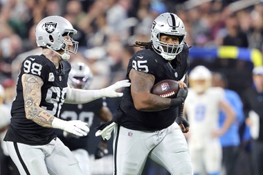 Las Vegas Raiders defensive tackle John Jenkins (95) runs for a touchdown after recovering a fumble by the Los Angeles Chargers during the second half of an NFL football game, Thursday, Dec. 14, 2023, in Las Vegas. (AP Photo/Steve Marcus)