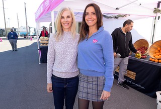Kelly Simonson, left, president of the UnitedHealthcare Healthplan of Nevada Medicaid, and Brooke Neubauer, founder and CEO of The Just One Project, pose at a Groceries on the Go pop-up market at the Desert Palms Apartments on Boulder Highway Thursday, Dec. 14, 2023. The market is a pilot program by Just One Project that will allow them to offer food shopping to people living in food deserts.