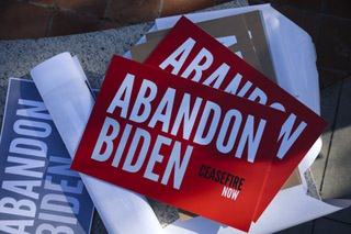 Signs are shown during a rally held to campaign against President Joe Bidens re-election at the Lloyd D George Courthouse, downtown, Monday, Dec. 18, 2023.