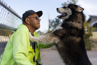 Jose Sanchez, 69, poses for a photo with Rocky, his 3-year-old Siberian Husky, at this home Wednesday, Dec. 20, 2023.