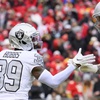 Las Vegas Raiders cornerback Nate Hobbs (39) celebrates a defensive stop against the Kansas City Chiefs with Raiders defensive end Maxx Crosby (98) during the first half of an NFL football game, Monday, Dec. 25, 2023 in Kansas City, Mo.