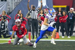 Kansas wide receiver Luke Grimm (11) celebrates a touchdown against UNLV during the second half of the Guaranteed Rate Bowl NCAA college football game Tuesday, Dec. 26, 2023, in Phoenix. Kansas won 49-36.