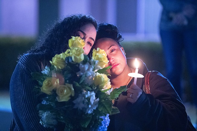 Mourners hold flowers and a candle during a vigil for Jonet Dominguez at Awaken Las Vegas Christian Church Thursday, Jan. 12, 2023. Jonet Dominguez, co-owner of All In Towing, was shot and killed at the business on Jan. 10.