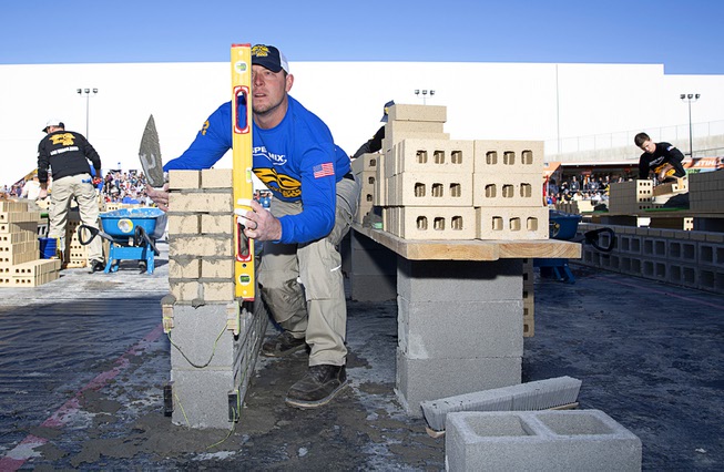 JT Payne, of Cape Girardeau, Mo., competes during the Spec Mix Bricklayer 500 at the Las Vegas Convention Center Wednesday, Jan. 18, 2023. The event, held during the World of Concrete convention, is a contest where masons compete to build a wall with the most bricks in 60 minutes.