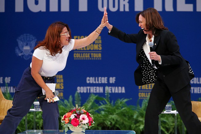 Vice President Kamala Harris, right, high fives with moderator Annie Gonzalez during a Fight For Our Freedoms event at the College of Southern Nevada-Cheyenne campus Thursday, Oct. 12, 2023, in North Las Vegas.