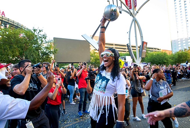 Las Vegas Aces forward A'ja Wilson holds up the trophy as she arrives at Toshiba Plaza for the Las Vegas Aces championship celebration Monday, Oct. 23, 2023. The Aces became back-to-back WNBA national champions after beating the New York Liberty in Game 4. After their pair of title runs, the Aces have sold out their season ticket allotment for 2024.