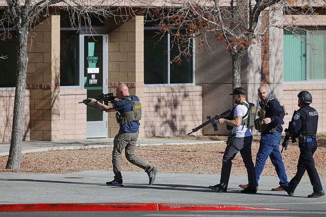 Law enforcement officers head into UNLV campus after reports of an active shooter Wednesday, Dec. 6, 2023.