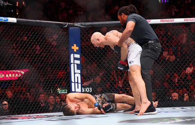 Featherweight fighter Josh Emmett, right, stands over Bryce Mitchell after a first round knockout during UFC 296 at T-Mobile Arena Saturday, Dec. 16, 2023.