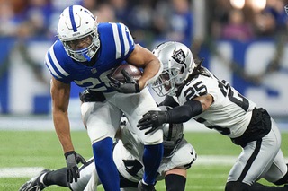Indianapolis Colts running back Jonathan Taylor (28) is tackled by Las Vegas Raiders safety Tre'von Moehrig (25) during the second half of an NFL football game Sunday, Dec. 31, 2023, in Indianapolis. (AP Photo/AJ Mast)