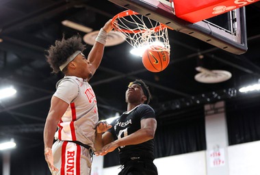 UNLV Rebels forward Rob Whaley Jr. (5) dunks in front of Bethesda University Flames forward Jonathan Ileleji (10) during an exhibition game at the Cox Pavilion Tuesday, Jan. 2, 2024.