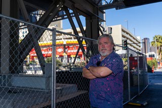Wade Bohn, owner of Jays Market on Flamingo, stands under the temporary bridge that was put up in front of his business, at the corner of Koval Lane and Flamingo Road during the F1 event in Las Vegas, says that they will continue to lose millions in revenue as long as this bridge still stands on January 4, 2024.