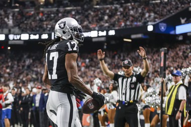 Las Vegas Raiders wide receiver Davante Adams (17) reacts after he completes a touchdown pass during the first half of an NFL football game against the Denver Broncos at Allegiant Stadium Sunday, Jan. 7, 2024.