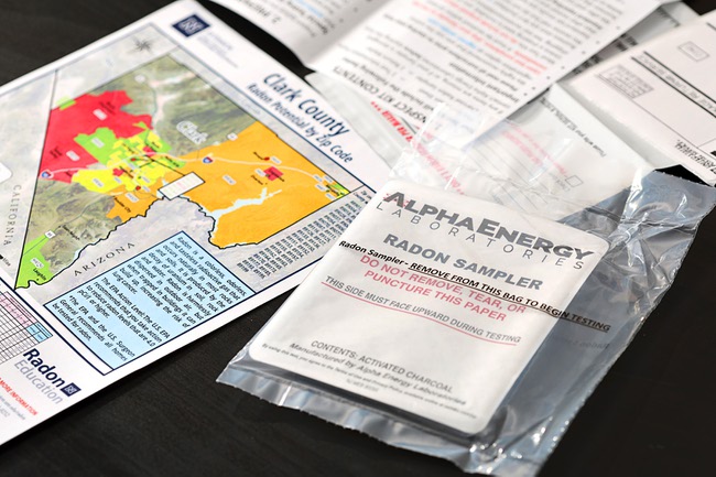 A map of Clark County showing radon potential by zip code is shown next to a radon test kit at the Local Realty office Thursday, Jan. 11, 2024. The red color indicates a high potential for radon exposure.