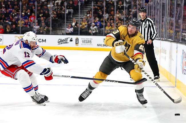 Vegas Golden Knights center Paul Cotter (43) passes the puck by New York Rangers center Nick Bonino (12) during the first period of an NHL hockey game at T-Mobile Arena Thursday, Jan. 18, 2024.