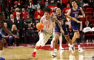 UNLV guard Brooklyn Hicks (13) is fouled by Fresno State guard Xavier DuSell (53) during the second half of an NCAA basketball game at the Thomas & Mack Center Tuesday, Jan. 30, 2024.