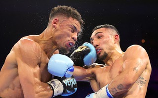 Jamaine Ortiz, left, takes a punch from WBO junior welterweight champion Teofimo Lopez during a fight at the Michelob Ultra Arena in Mandalay Bay Thursday, Feb. 8, 2024, in Las Vegas. Lopez retained his title with a unanimous decision.
