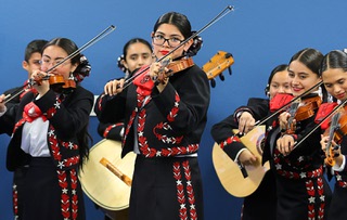 Violinists with Mariachi Los Bravos perform during a Communities In Schools news conference at JD Smith Middle School Tuesday, Feb. 20, 2024. Communities in Schools of Nevada announced it has been awarded a five-year $11,852,258 grant from the United States Department of Education.