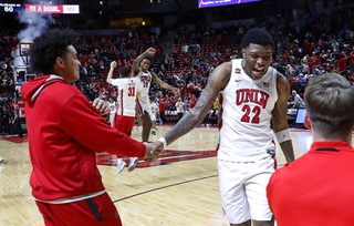 UNLV Rebels forward Karl Jones (22) celebrates with teammates after the Rebels beat the Colorado State Rams in an NCAA basketball game at the Thomas & Mack Center Saturday, Feb. 24, 2024. UNLV Rebels guards Nick Walters (31) and Luis Rodriguez (15) are in the background.