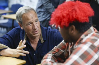 Mike Rowe, creator and host of the TV series Dirty Jobs and founder of the mikeroweWORKS Foundation, speaks to Lyric Rojas, 16, at Western High School Monday, Feb. 26, 2024. Rowe’s visit to the school was to announce a new program, created in partnership between his foundation and the Engelstad Foundation, with the goal of providing full-ride scholarships for trade programs to students upon graduation.