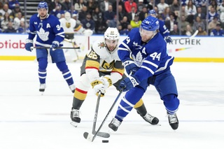 Toronto Maple Leafs' Morgan Rielly (44) battles for the puck with Vegas Golden Knights' Michael Amadio (22) during the first period in Toronto, on Tuesday, Feb. 27, 2024. 


