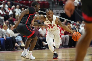 UNLV guard Jackie Johnson III (24) drives against San Diego State guard Darrion Trammell during the first half of an NCAA college basketball game Tuesday, March 5, 2024, in Las Vegas.