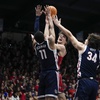 Saint Mary's guard Aidan Mahaney, center, shoots while defended by Gonzaga guard Nolan Hickman (11) and forward Braden Huff (34) during the first half of an NCAA college basketball game Saturday, March 2, 2024, in Moraga, Calif.