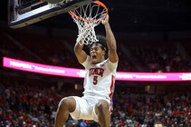 UNLV Rebels forward Rob Whaley Jr. (5) hangs on the rim after dunking against the San Diego State Aztecs during overtime of an NCAA college ...