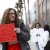 Shelley Foley holds a sign Thursday, March 14, 2024, during a rally at the Regional Justice Center for Jonathan Lewis, 17, who died on Nov. 7, 2023, almost a week after a group of classmates beat him near Rancho High School.