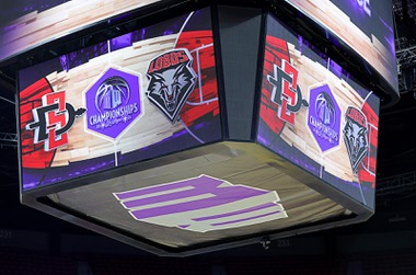 The logos for San Diego State and New Mexico are displayed on the video board above the court before an NCAA college basketball championship game at the Mountain West Conference tournament Saturday, March 16, 2024, in Las Vegas.