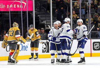 Tampa Bay Lightning players celebrate an empty net goal as Vegas Golden Knights goaltender Adin Hill (33) comes back onto the ice by defenseman Shea Theodore (27) during the third period of an NHL hockey game at T-Mobile Arena Tuesday, March 19, 2024.