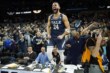 Yale guard Yassine Gharram (24) stands on a table after celebrating with fans after Yale upset Auburn in a first-round college basketball game in the NCAA Tournament in Spokane, Wash., Friday, March 22, 2024. 


