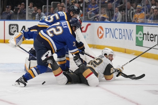 Vegas Golden Knights' Michael Amadio (22) falls as St. Louis Blues' Justin Faulk (72) and Colton Parayko defend during the first period Monday, March 25, 2024, in St. Louis. 


