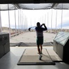 Brett Jones of Las Vegas tees off at Atomic Golf, a new golf entertainment venue, Friday, March 29, 2024.