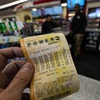 A Powerball lottery ticket is dipslayed seen inside a convenience store, Monday, April 1, 2024, in Kennesaw, Ga.