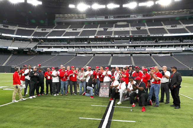 Members of the 1984 UNLV football team pose on the field at the before the UNLV Football Spring Showcase at Allegiant Stadium Saturday, April 6, 2024. Led by head coach Harvey Hyde, the 1984 team finished with a record of 11-2 after going undefeated in league play and downing Toledo in the California Bowl.