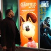 Photo: An attendee walks past advertisements for upcoming