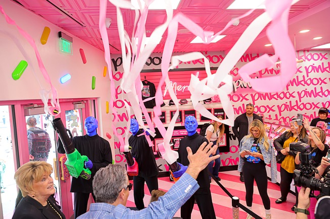 Members of Blue Man Group shoot streamers over guests and Las Vegas Mayor Carolyn Goodman, left, during a promotional kick-off for Blue Man Group-inspired doughnuts at The Plaza in downtown Las Vegas Friday, April 12, 2024. The limited-edition doughnuts are called Blue Poo and Throwdown.