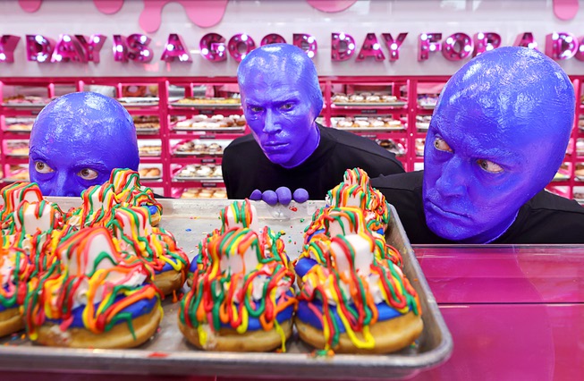 Members of Blue Man Group pose behind Blue Man Group-inspired doughnuts at The Plaza in downtown Las Vegas Friday, April 12, 2024. The limited-edition doughnuts are called Blue Poo and Throwdown.