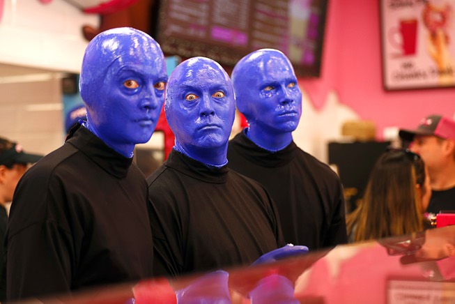 Members of Blue Man Group pose behind the counter during a promotional kick-off for Blue Man Group-inspired doughnuts at The Plaza in downtown Las Vegas Friday, April 12, 2024. The limited-edition doughnuts are called Blue Poo and Throwdown.