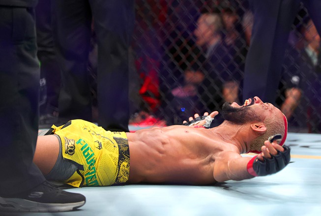 Deiveson Figueiredo celebrates on the canvas after defeating Cody Garbrandt in a bantamweight bout during UFC 300 at T-Mobile Arena Saturday, April 13, 2024, in Las Vegas. Figueiredo won the bout by submission in the second round.