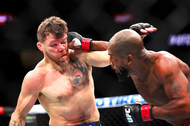 Jim Miller, left, takes a punch from Bobby Green in a lightweight bout during UFC 300 at T-Mobile Arena Saturday, April 13, 2024, in Las Vegas. Green won the bout by unanimous decision. 